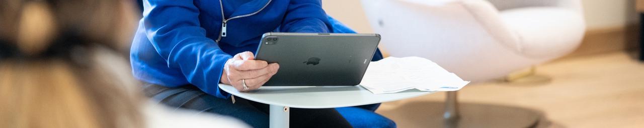 President Mantella holding and looking at an iPad in her hands